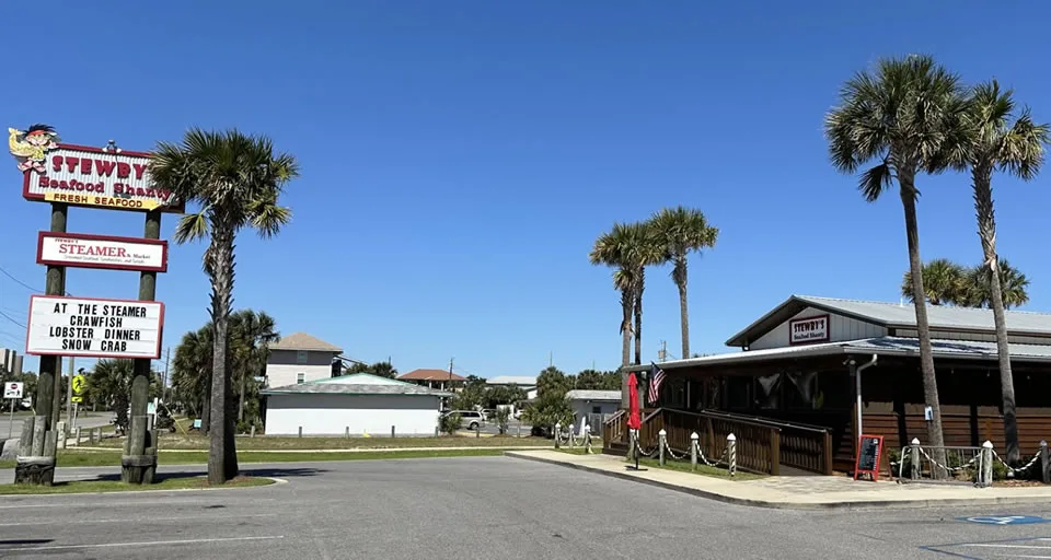 Stewbys seafood restaurant with palm trees and signage