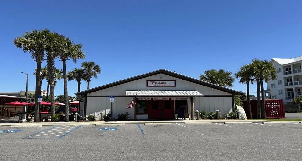 Restaurant with palm trees and outdoor seating