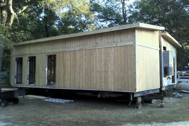 Unfinished wooden modular home in construction site.