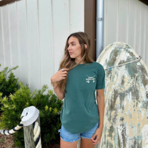 Fish-Eat-Repeat-Blue-Spruce-front600x600 Woman in green top and denim shorts outdoors.
