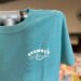 Stewby's Seafood Shanty logo on teal t-shirt
