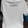White shirt with seafood pricing slogan on back.