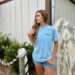 Woman in blue Stewby's t-shirt and denim shorts.