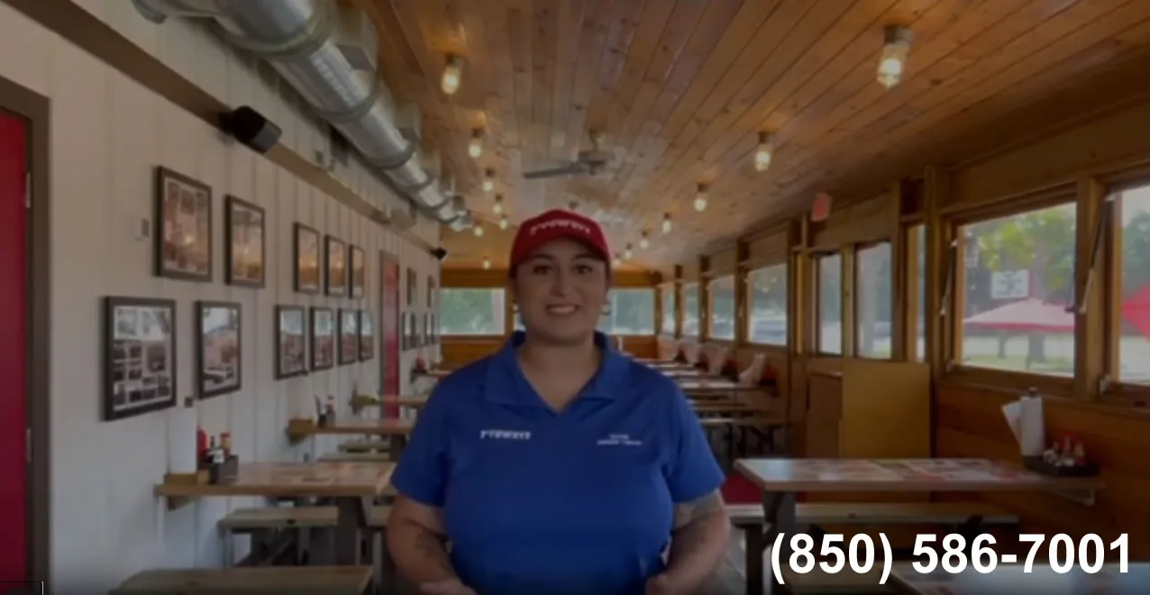 Smiling employee in cozy restaurant interior.