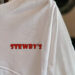 White shirt with red 'STEWBY'S' logo