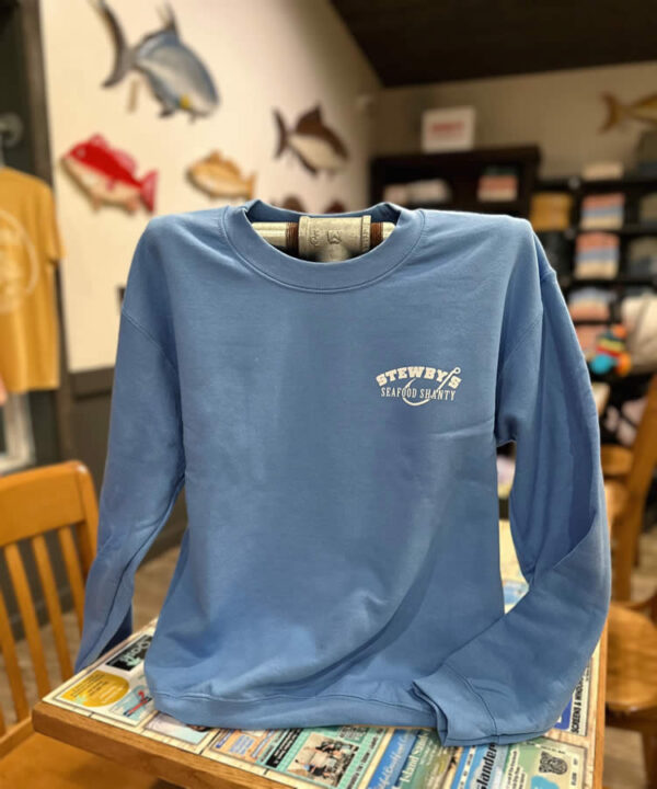 4953926663191634394 Blue Stewby's Seafood Shanty sweatshirt on chair