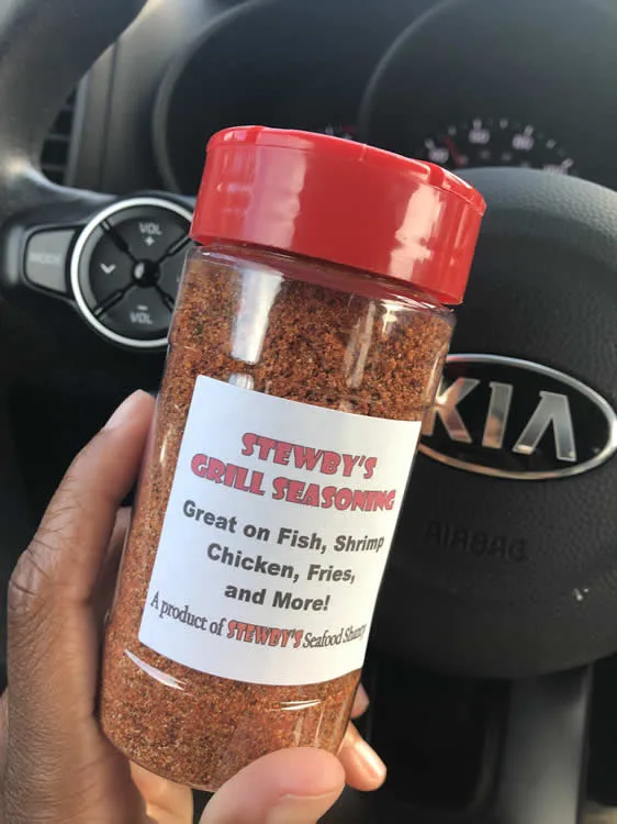 Stewby's grill seasoning jar held in a car.
