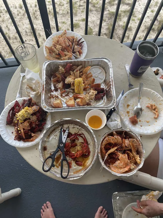 Seafood boil with corn and sausages on a table.