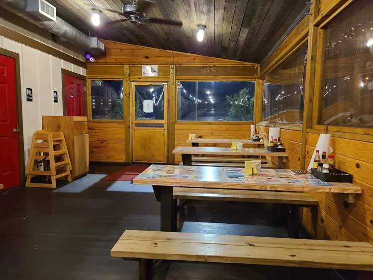 Rustic wooden restaurant interior with benches.