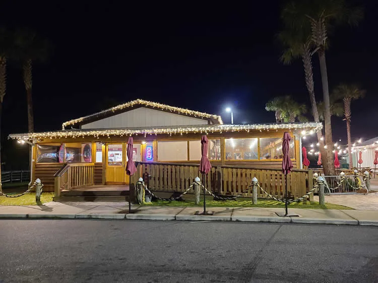 Cozy restaurant with festive string lights at night.