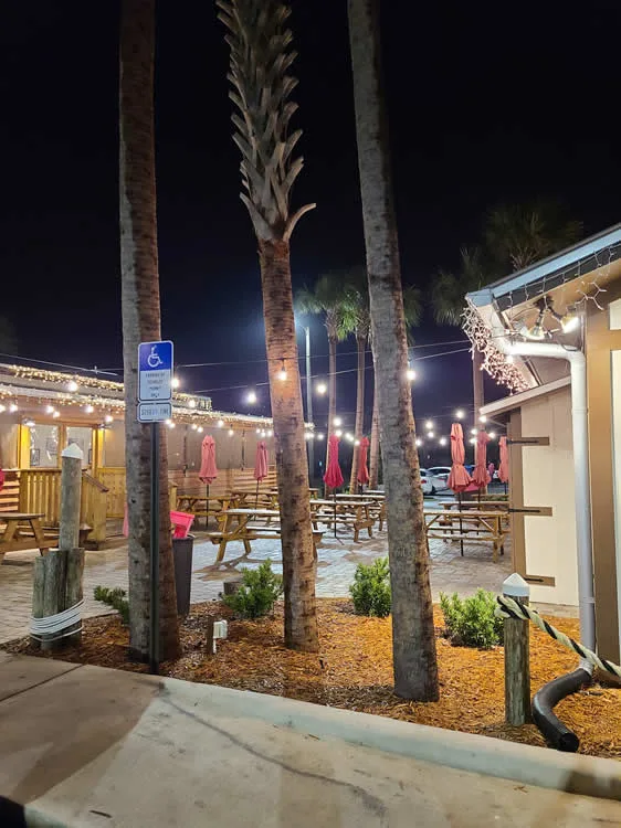 Outdoor dining area with string lights at night.
