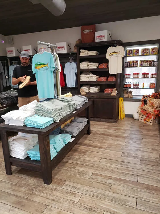 Clothing store with folded shirts and shelves.
