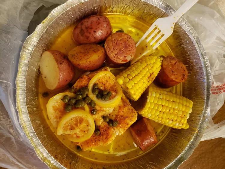 Seafood boil with potatoes, corn, and sausage.