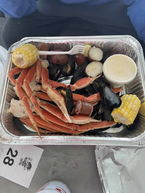 Seafood platter with crab, mussels, sausage, and corn
