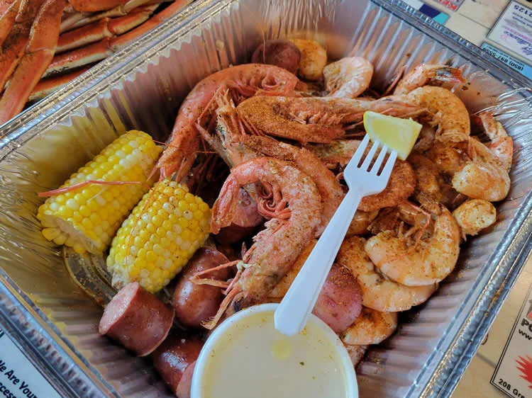 Seafood boil with shrimp, corn, sausage, and lemon.