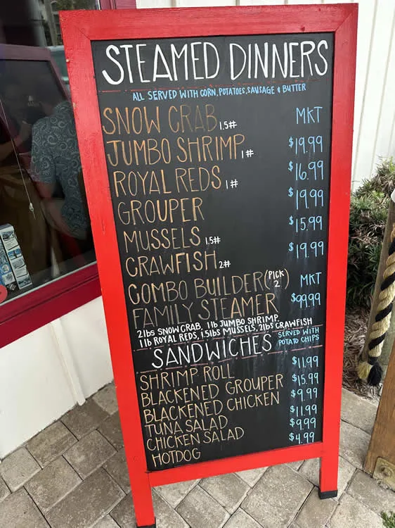 Steamed dinners and sandwiches menu board.
