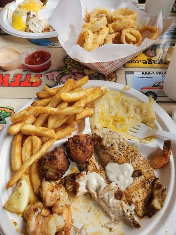 Seafood platter with fries and onion rings.