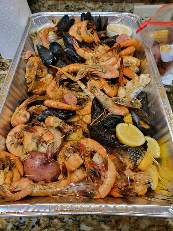 Seafood boil with shrimp, mussels, and lemons.