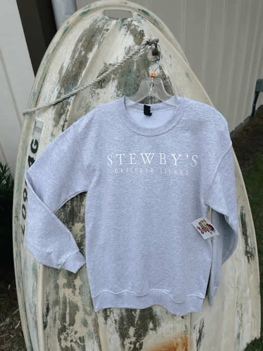 06FA9E5D-9841-4BFB-BEDA-CE9A98B50142 Gray Stewby's sweatshirt hanging on weathered boat.