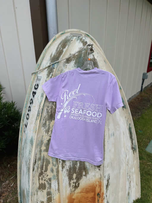 DCA0A984-192E-4E50-9070-1F6F646064C0 Purple seafood shirt on weathered boat background.